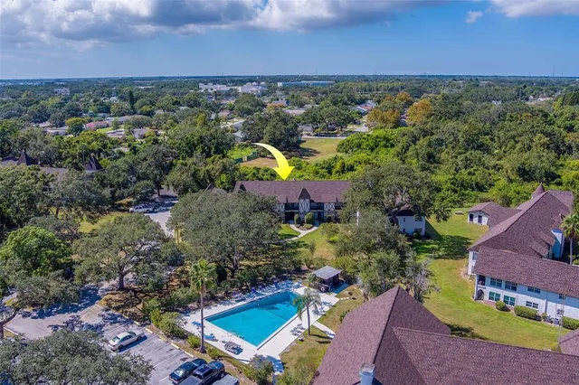an aerial view of a houses with a yard