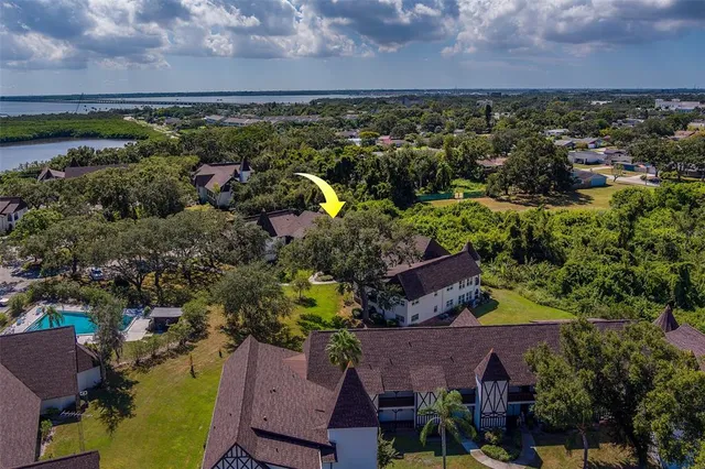 an aerial view of a house with a garden and lake view