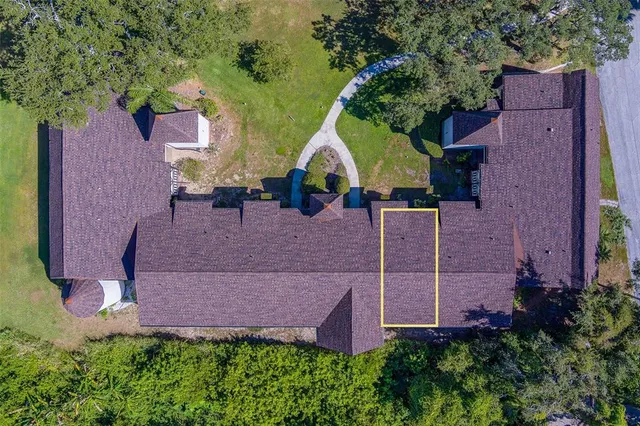 a view of a brick house with a small yard