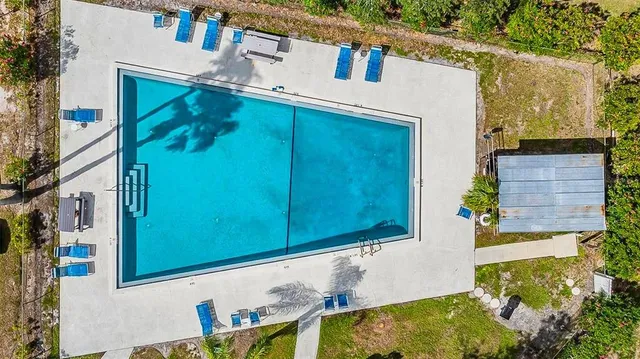 a view of swimming pool with chairs