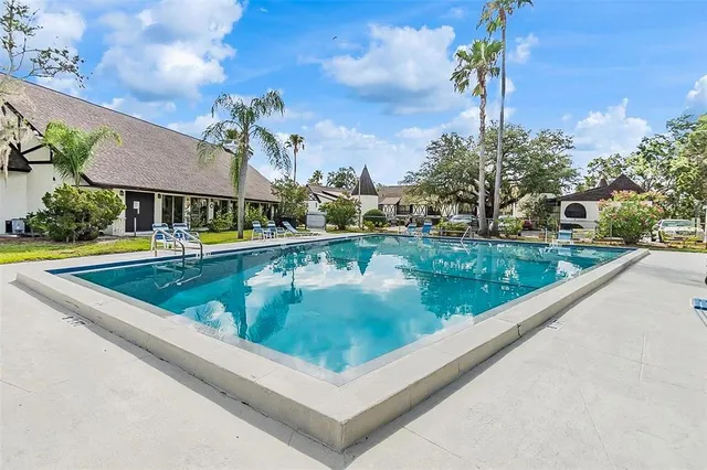 a view of a room with furniture and a chandelier