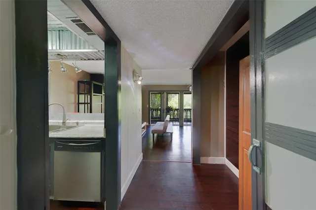 a kitchen with stainless steel appliances a stove microwave and sink