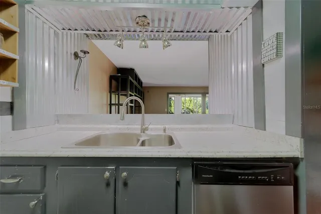 a kitchen with kitchen island a sink appliances and cabinets