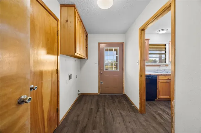 a view of a hallway with wooden floor and closet
