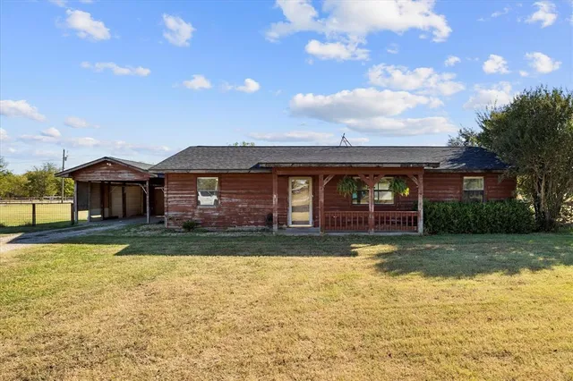 a view of a house with swimming pool next to a yard