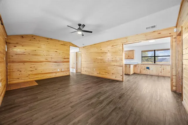 a view of a room with wooden floor cabinet and windows