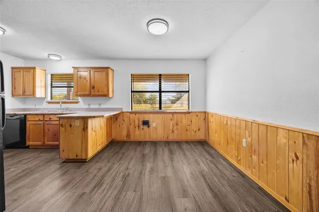 a view of kitchen with wooden floor and window