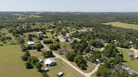 an aerial view of residential house with outdoor space and trees
