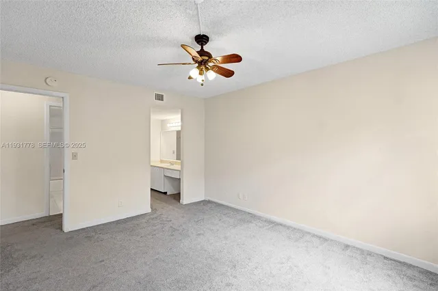 a view of a livingroom with a ceiling fan and window