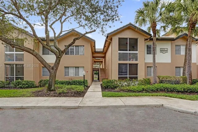 a front view of a house with a yard and a garage