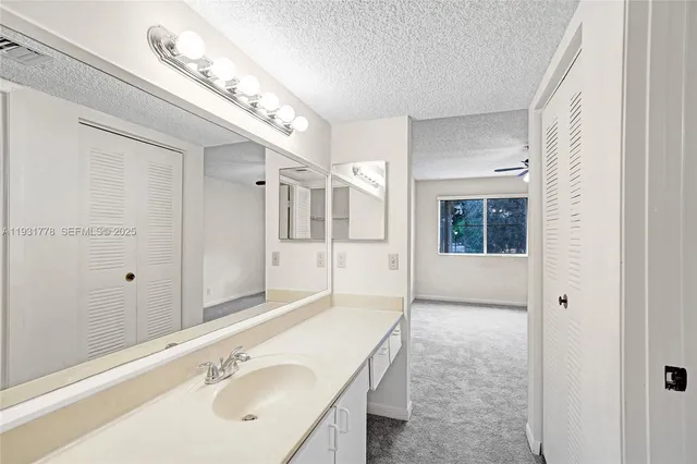 a bathroom with a sink and mirror