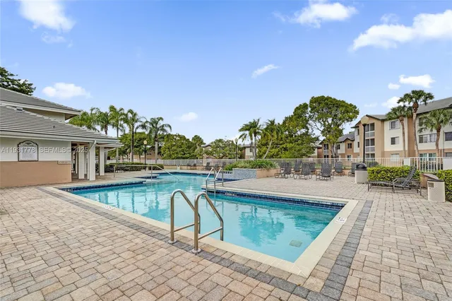 a view of a house with backyard sitting area and garden