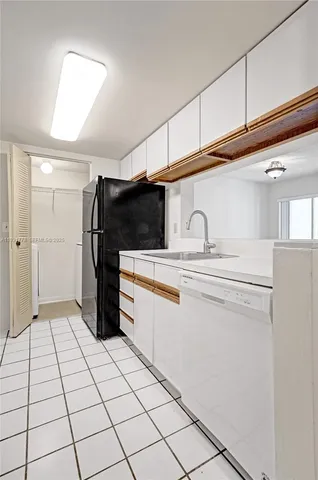 a kitchen with stainless steel appliances a refrigerator and cabinets