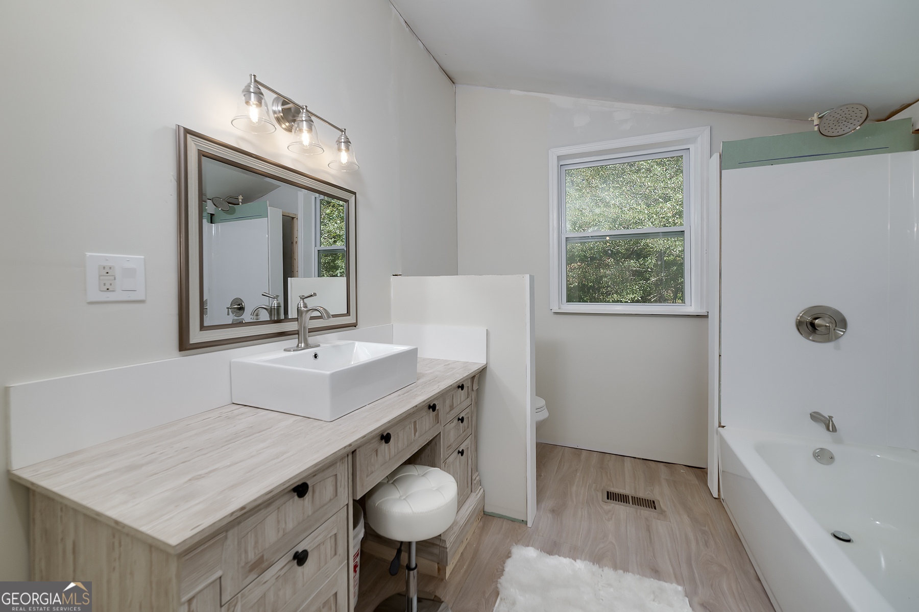 447 Grandview Road Mansfield, GA 30055 - Photo 48 of 65 a bathroom with a tub sink and mirror