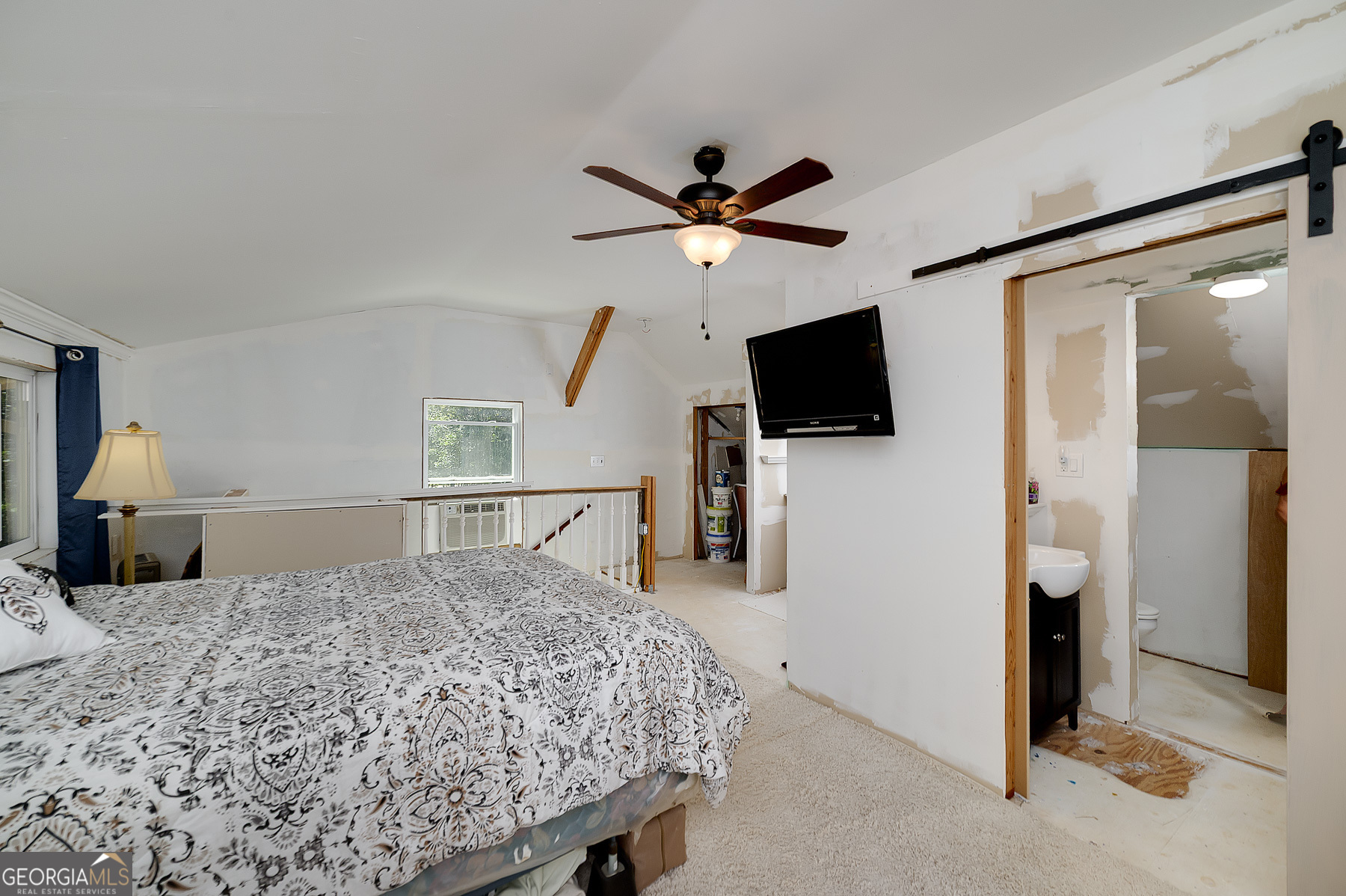 447 Grandview Road Mansfield, GA 30055 - Photo 56 of 65 a bedroom with a bed and a flat screen tv