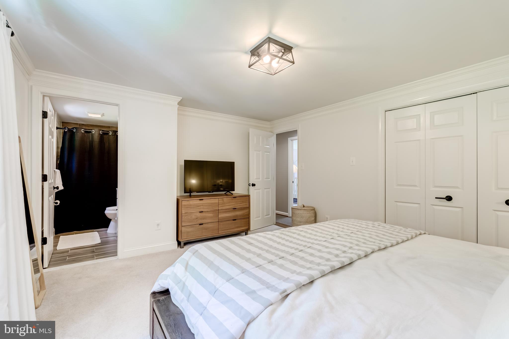 11926 Appling Valley Road Fairfax, VA 22030 - Photo 39 of 60 a bedroom with a bed and a flat screen tv
