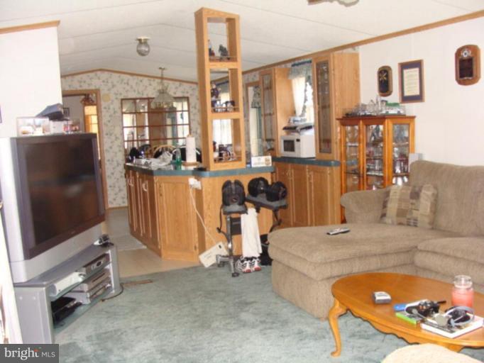 122 German Chapel Road Prince Frederick, MD 20678 - Photo 2 of 7 a living room with furniture a flat screen tv and large window