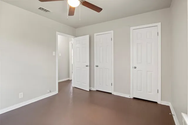 an empty room with a empty space and a ceiling fan