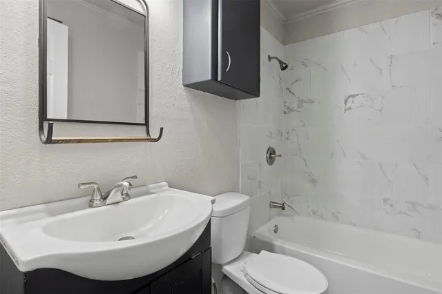 a bathroom with a sink toilet and bathtub