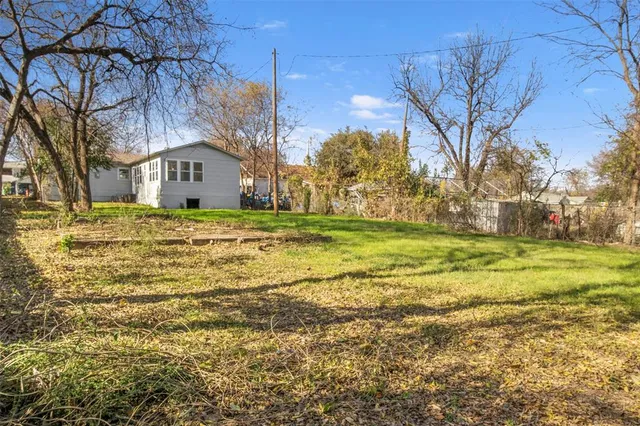 a big house with a big yard and large trees