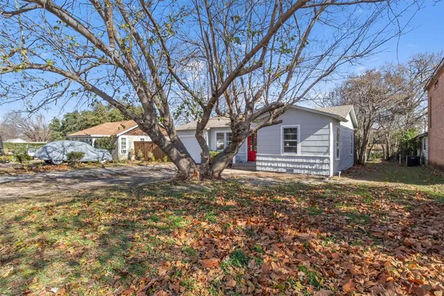 a backyard of a house with large trees and outdoor space