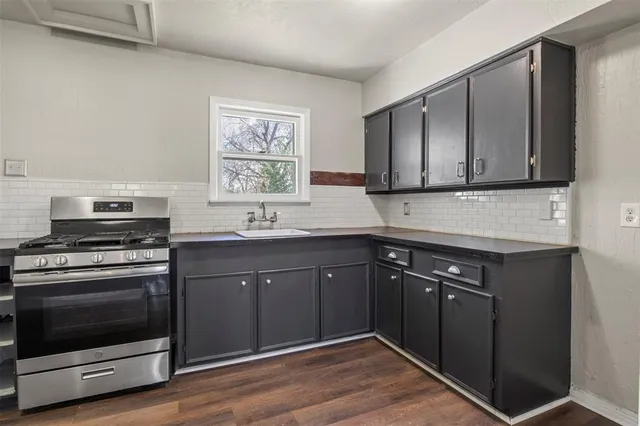 a kitchen with stainless steel appliances granite countertop a stove and a sink