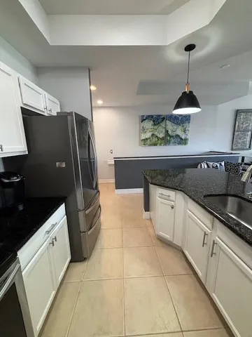 a kitchen with stainless steel appliances a stove a sink and a microwave