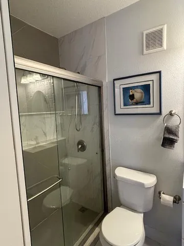 a view of a hallway with a livingroom and a bathroom with sink