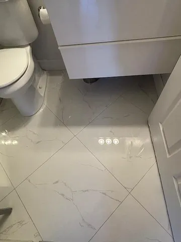 a bedroom with a bed and dresser with mirror