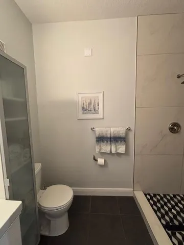 a living room with furniture a chandelier and a fireplace