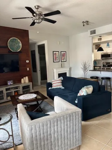 a living room with furniture and kitchen view