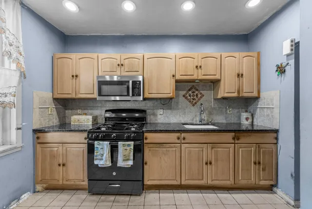a kitchen with stainless steel appliances granite countertop a stove and a sink
