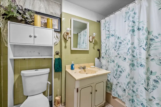 a bathroom with a sink toilet and vanity