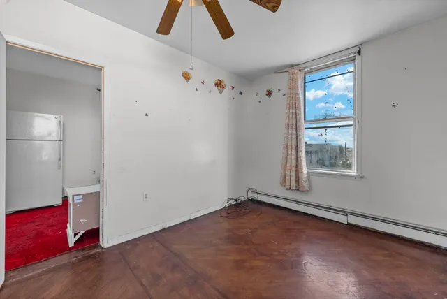 an empty room with windows and closet