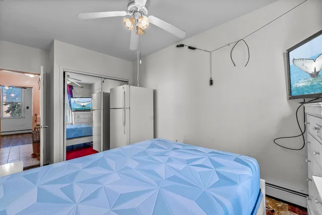 a bedroom with a bed and a mirror