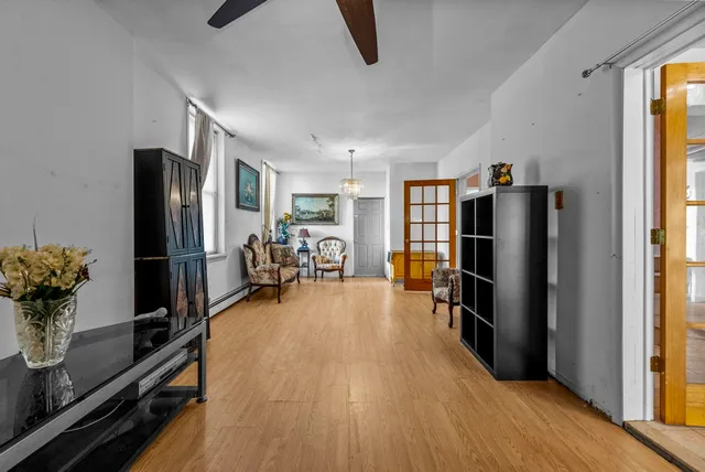 a very nice looking room with a large window and a wooden floor