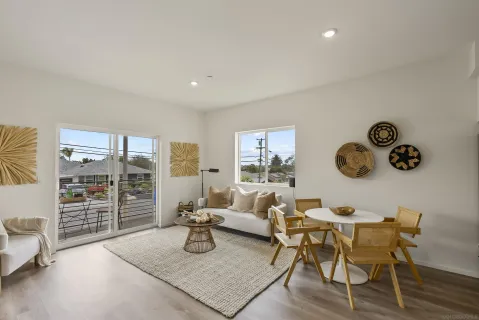 a living room with furniture and a floor to ceiling window
