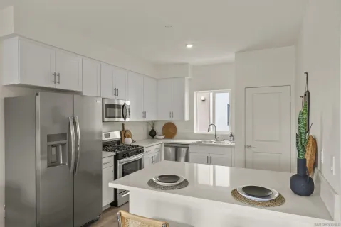 a kitchen with refrigerator and stove