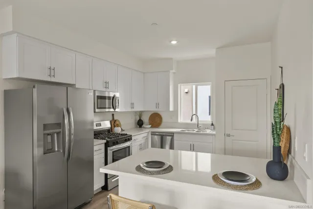 a kitchen with refrigerator and stove