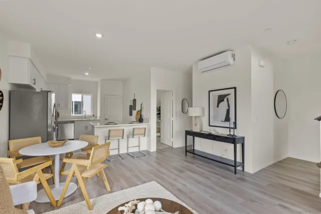 a dining room with furniture a rug and wooden floor