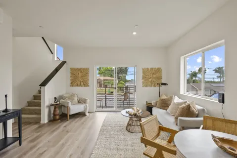a living room with furniture and a floor to ceiling window