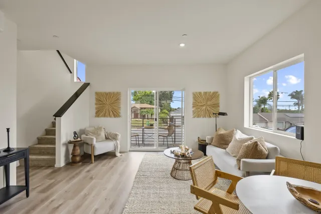 a living room with furniture and a floor to ceiling window