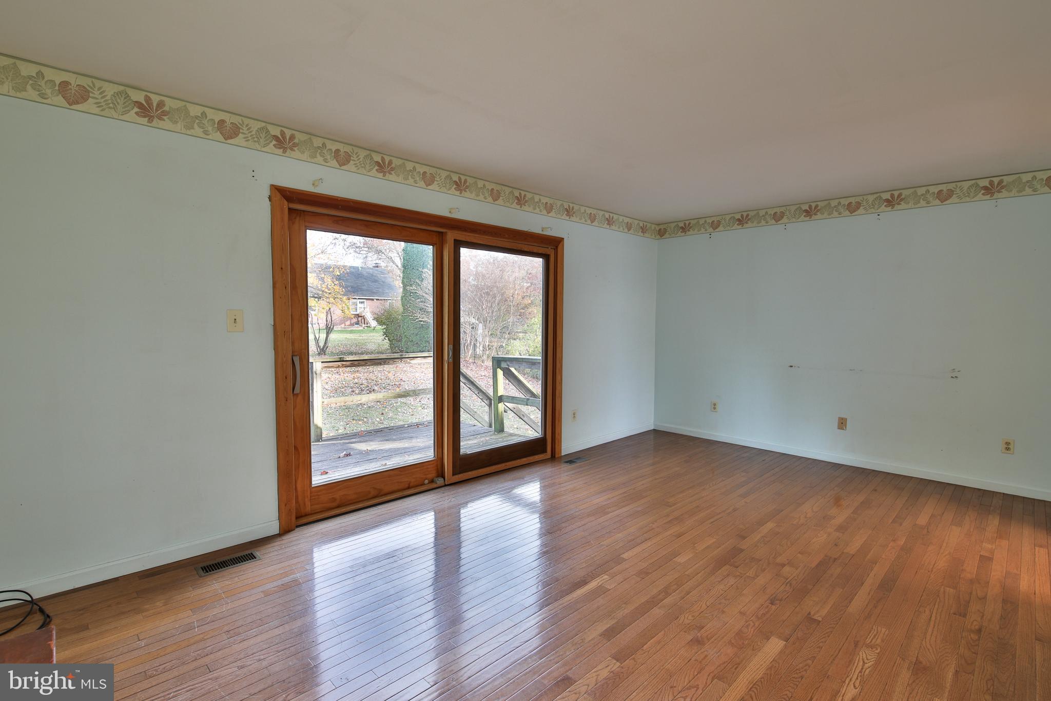 531 Locust Avenue Westminster, MD 21157 - Photo 12 of 31 a view of an empty room with wooden floor and a window