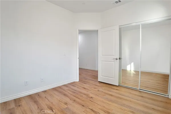 an empty room with wooden floor