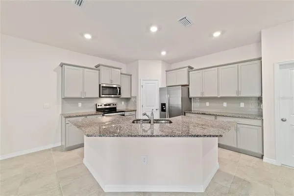a kitchen with stainless steel appliances granite countertop a granite counter tops and a stove