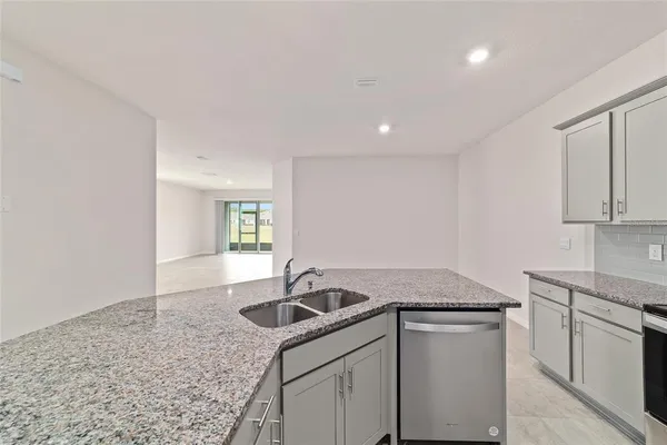 a kitchen with a sink cabinets and window