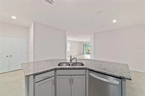 a sink with granite countertop a sink and cabinets