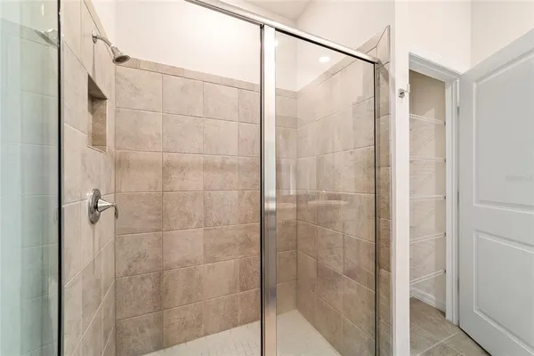 a bathroom with a glass shower door