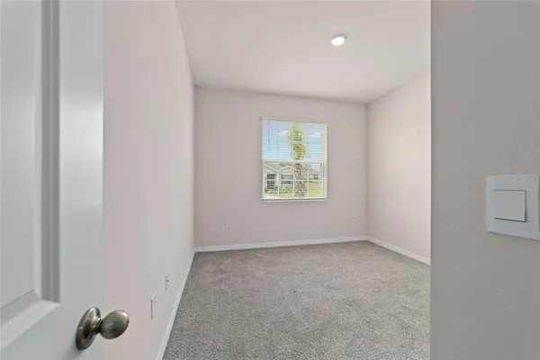 an empty room with windows and closet