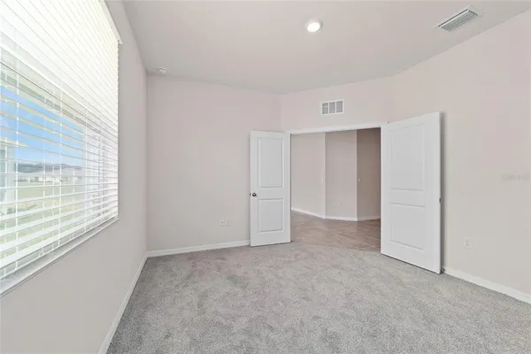 a view of an empty room with a window